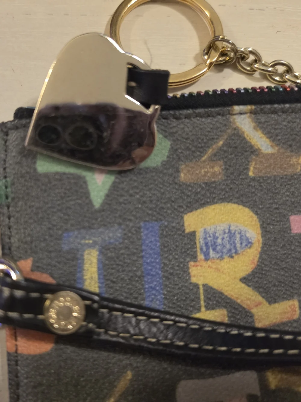 Dooney & Bourke Vintage multicolor letter/graffiti print coated Wristlet
